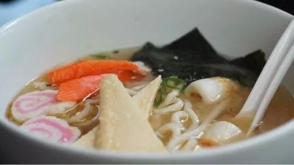 Japanese dish ramen in a white color bowl with a white color spoon.